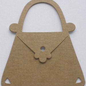 May include: A brown paper cutout of a handbag with a simple flower design on the flap.