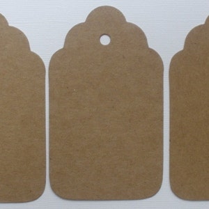 May include: Three brown paper gift tags with scalloped edges and a hole punched at the top.
