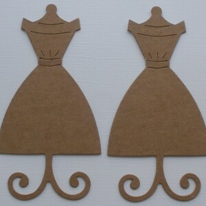 May include: Two brown cardboard dress forms with a stand. The dress forms are cut out in the shape of a dress with a simple bodice and a full skirt. The stands are shaped like a simple swirl.