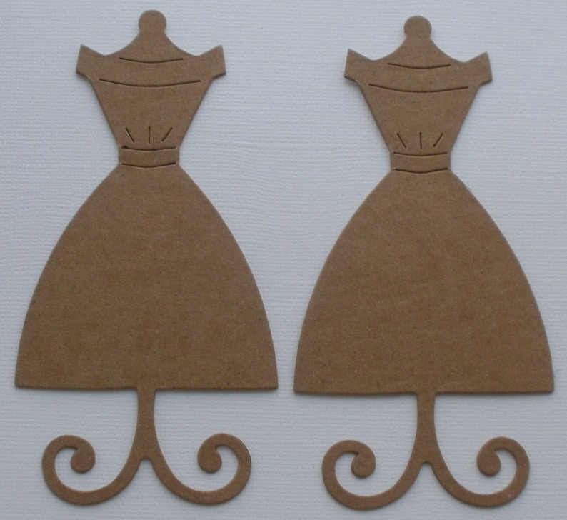 May include: Two brown cardboard dress forms with a stand. The dress forms are cut out in the shape of a dress with a simple bodice and a full skirt. The stands are shaped like a simple swirl.