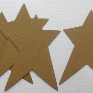 May include: Five brown paper stars of different sizes. The stars are cut out and have a rough texture.