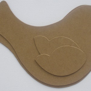 May include: A brown paper bird cutout with a layered design. The bird has a rounded body and a long, pointed beak.