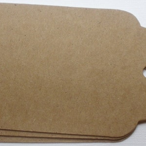 May include: Three brown paper gift tags with scalloped edges and a hole punched in the top.