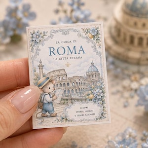 May include: A rectangular card featuring an illustration of a mouse wearing a hat and overalls, holding a map in front of the Colosseum. The text reads LA GUIDA DI ROMA LA CITTÀ ETERNA and SCOPRI STORIA, LUOGHI E TESORI NASCOSTI with blue floral accents.