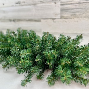 May include: A lush green garland of artificial pine branches, perfect for adding a touch of holiday cheer to your home decor.