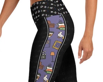 May include: Black leggings with a purple stripe featuring cartoon images of a couch, coffee cups, and a picture frame. The leggings have the text "How You Doin'" printed on the waistband.