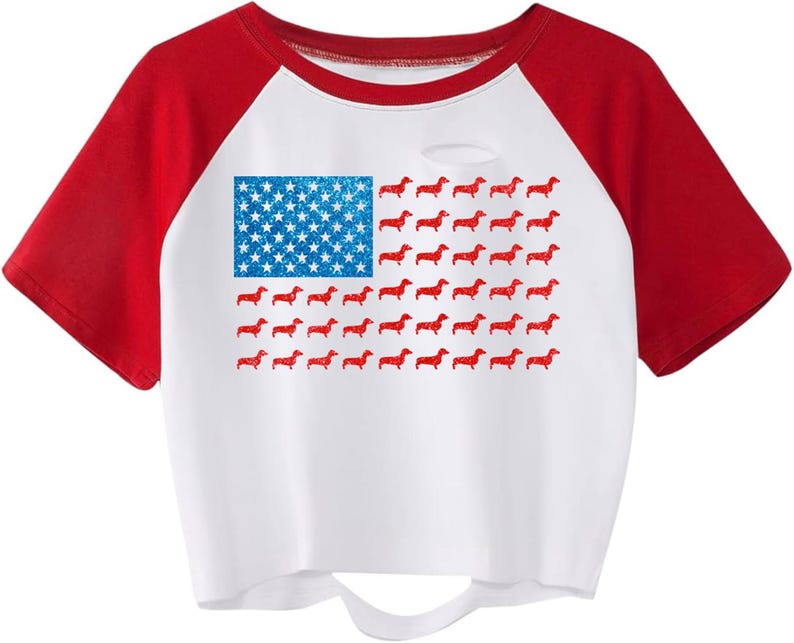 May include: White crop top with red sleeves. The design is an American flag, with blue stars and red dachshunds replacing the stripes. The top has a distressed look with a small hole near the neckline.