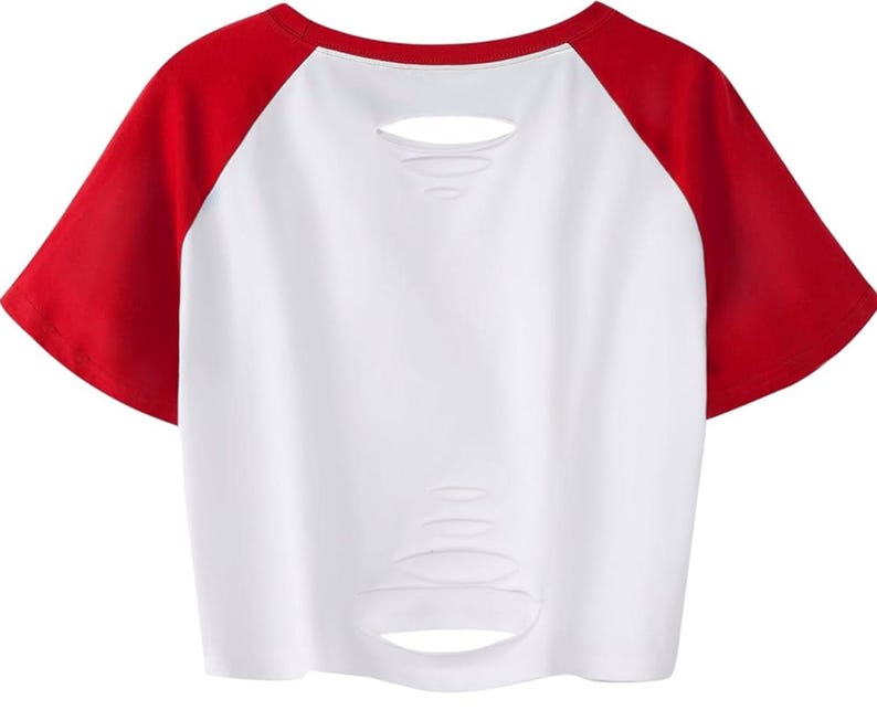 May include: White crop top with red raglan sleeves. The shirt features distressed detailing across the front. A casual style, suitable for everyday wear.