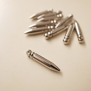 20 new raw brass bullet charm with nice weigh 18 mm long with new plating in steel color