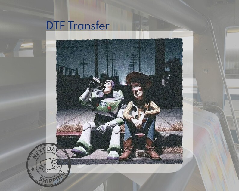 May include: A DTF transfer featuring a graphic illustration of two toy characters sitting on a curb at night. One character wears a white, green, and purple space suit, while the other wears a cowboy hat, yellow shirt, and blue jeans. The text DTF Transfer is visible.