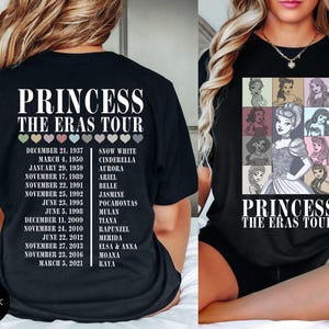 May include: Black t-shirt featuring the text "PRINCESS THE ERAS TOUR" with a list of dates and princess names. The front of the shirt displays a grid of princess illustrations. The shirt is a crew neck.