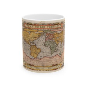 May include: A white ceramic mug with a vintage world map design. The map is in shades of brown, yellow, green, and red. The text "TYPVVS ORBIS TERRARVM" is printed at the top of the map.