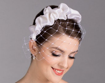 White bridal headband in modern crunchy style with big hole face veil.