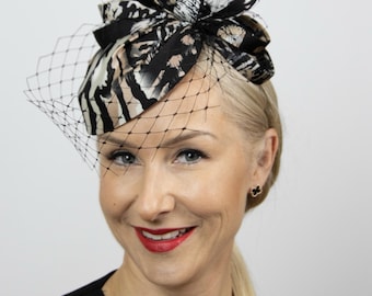 Small animal print pillbox hat with face veil. Glamorous black fascinator hat for women.