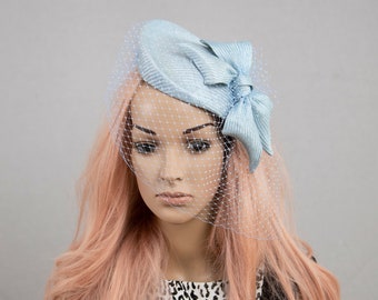 Ice blue, light blue percher hat with face veil. Pale blue wedding guest hat.