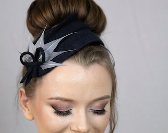 Blue fascinator hat from felt and feathers.