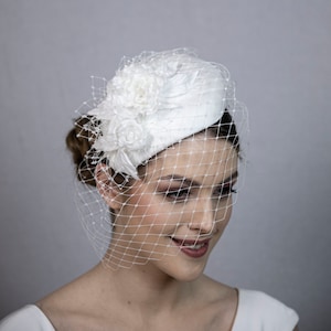 White classical silk percher hat for the bride. Bridal hat with face veil.