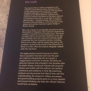 May include: Book cover with a black background and white text. The title is "Nero: The Man Behind The Myth". The text describes the book as a major exhibition at the British Museum. The book explores the life of the Roman emperor Nero, challenging traditional narratives and presenting a new perspective on his reign.