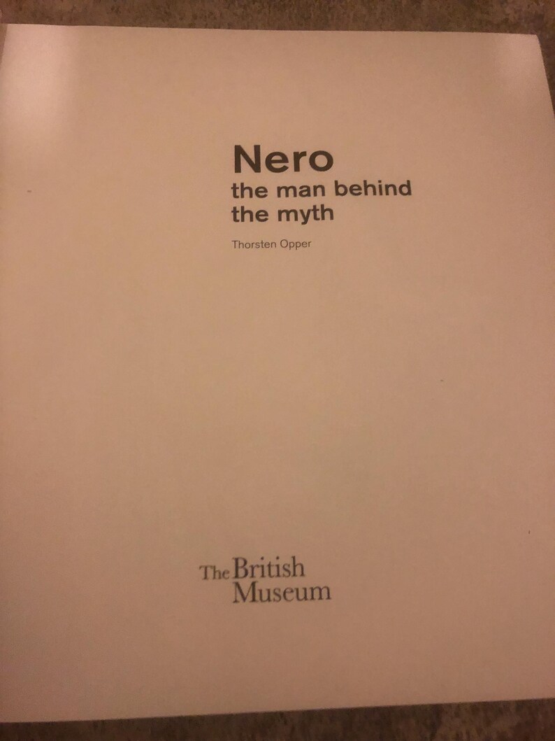 May include: Book cover with the title "Nero the man behind the myth" by Thorsten Opper. The cover is white with black text and the logo "The British Museum" at the bottom.
