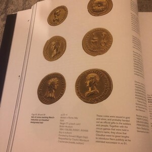 May include: Set of four gold coins featuring the profile of a Roman emperor. The coins are from the reign of Nero, the Roman emperor from 54 to 68 AD. The coins are 77 grams each and were minted in Rome, Italy. The coins are part of the British Museum collection.