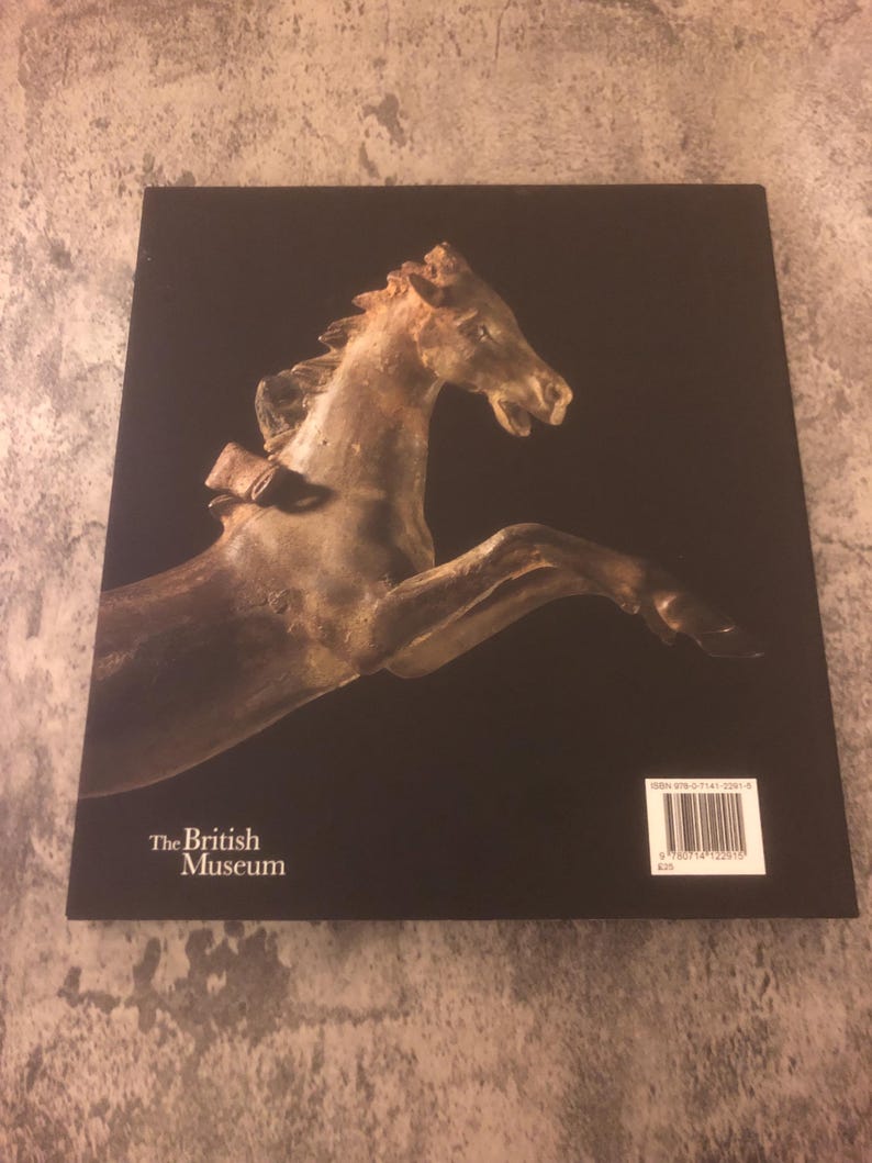 May include: The back cover of a book titled "The British Museum". The cover features a photograph of a bronze horse sculpture. The book's ISBN number is printed on the back cover.