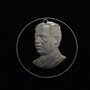 IRAQ - cut coin pendant - SADDAM HUSSEIN - 1980