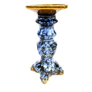 May include: A set of three ceramic mugs with a speckled, matte finish. Each mug features a different color: light blue, cream, and gray. The mugs have a simple, modern design and a comfortable handle.