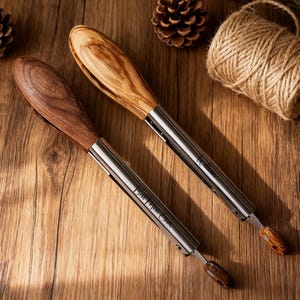May include: Two bottle openers with wooden handles and stainless steel accents are shown on a wooden surface. One has a light wood handle, the other a dark wood handle. The text "Best Man Ever" and "William" are engraved on the openers.