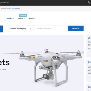 May include: A white drone with gold accents, a camera, and four propellers. The drone is on a white background. The text "Gadgets" is above the drone. The text "The 10 Best Man Collection 2018" is below the drone. The text "$120.00 $295.00" is below the text "The 10 Best Man Collection 2018". The text "BUY NOW" is below the price.