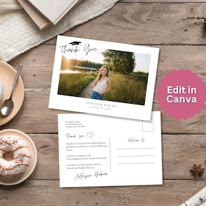 May include: A graduation thank you postcard featuring a photo of a person in a field. The postcard includes the text "Thank You" and "Addison Baker Class of 2023". The postcard is on a wooden surface with a cup of coffee and a donut.