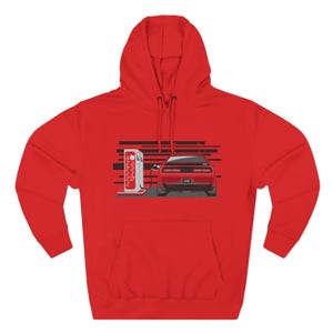 May include: A red hoodie with a graphic of a red car at a petrol pump. The car has a spoiler and the pump has Japanese text. The sweatshirt has a front pocket and a drawstring hood.
