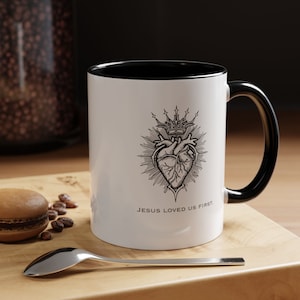 Jesus Loved Us First Catholic Accent Coffee Mug (11oz)