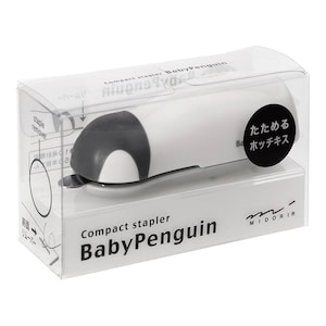 May include: A white and gray compact stapler in a clear plastic case. The stapler is shaped like a penguin and has the words "Compact stapler BabyPenguin" printed on the packaging. The stapler also has the words "たためる ホッチキス" printed on a black circle.