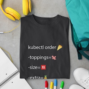 May include: Black t-shirt with the text "kubectl order" and emojis for pizza, bacon, and a pineapple. The text also includes "size=XL" and "extra=".