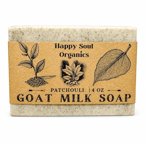 Puede incluir: Una pastilla rectangular de jabón de leche de cabra con aspecto beige claro moteado. Una banda de papel marrón envuelve el jabón, mostrando el texto "Happy Soul Organics" y "Patchouli | 113 g". También se presentan ilustraciones botánicas.