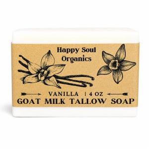 May include: A rectangular white bar of soap wrapped in a tan paper label. The label features black ink illustrations of vanilla flowers and text reading Happy Soul Organics, VANILLA, 4 OZ, and GOAT MILK TALLOW SOAP with decorative arrows.