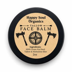 May include: A round black tin of Happy Soul Organics Tallow Face Balm. The tan label features black text, two axes, and a circular shield graphic. It lists ingredients as 100% Grass-Fed Beef Tallow & Methylene Blue with a net weight of 2oz.