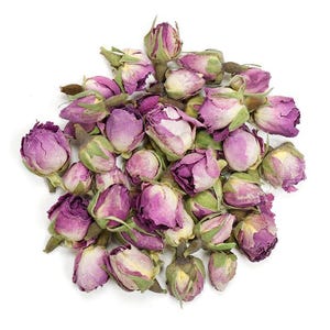 May include: A cluster of dried rose buds featuring shades of deep magenta, soft pink, and muted purple, each with small green sepals at the base. The petals are tightly furled in a rounded shape, creating a dense, textured pile of floral elements.
