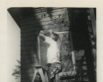 Original Vintage Photo Snapshot Man on Ladder Drinking From Bottle 1945