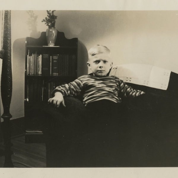 Original Vintage Photo Snapshot Serious Boy Sitting in Chair by Bookcase 1930s