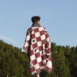 a person standing in a field with a blanket