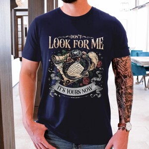 a man with a tattooed arm wearing a t - shirt
