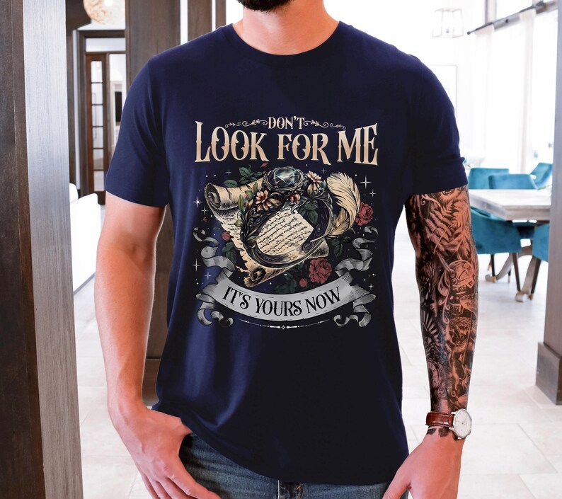 a man with a tattooed arm wearing a t - shirt