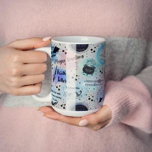 a woman is holding a coffee mug in her hands