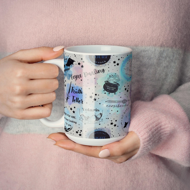 a woman is holding a coffee mug in her hands