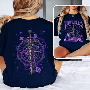 a woman sitting on a bed wearing a t - shirt