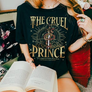 a woman sitting on the floor reading a book