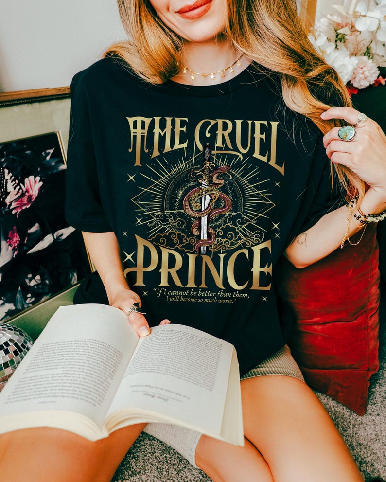 a woman sitting on the floor reading a book