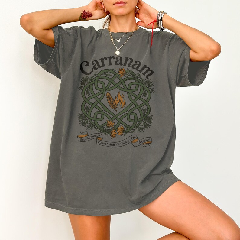Gray t-shirt with a Celtic knot design, feathers, and text "Carranam".