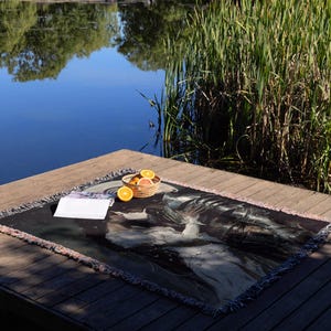 a plate of food on a wooden table next to a body of water